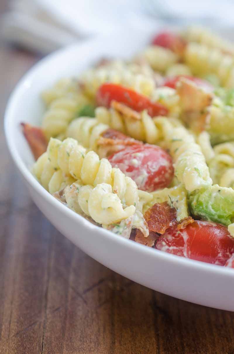 Make all the friends this summer with this Bacon Tomato Avocado Pasta Salad. It's a family favorite with crispy bacon, creamy avocado and sweet summer tomatoes.